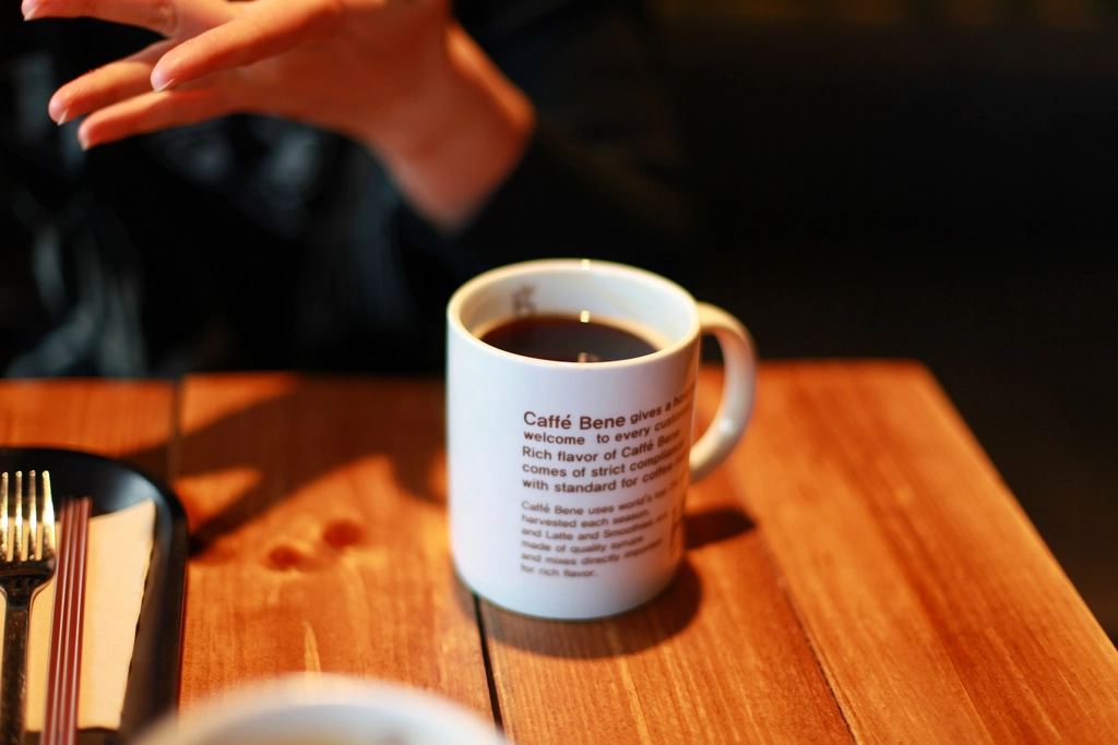A full mug of coffee on a wooden café table